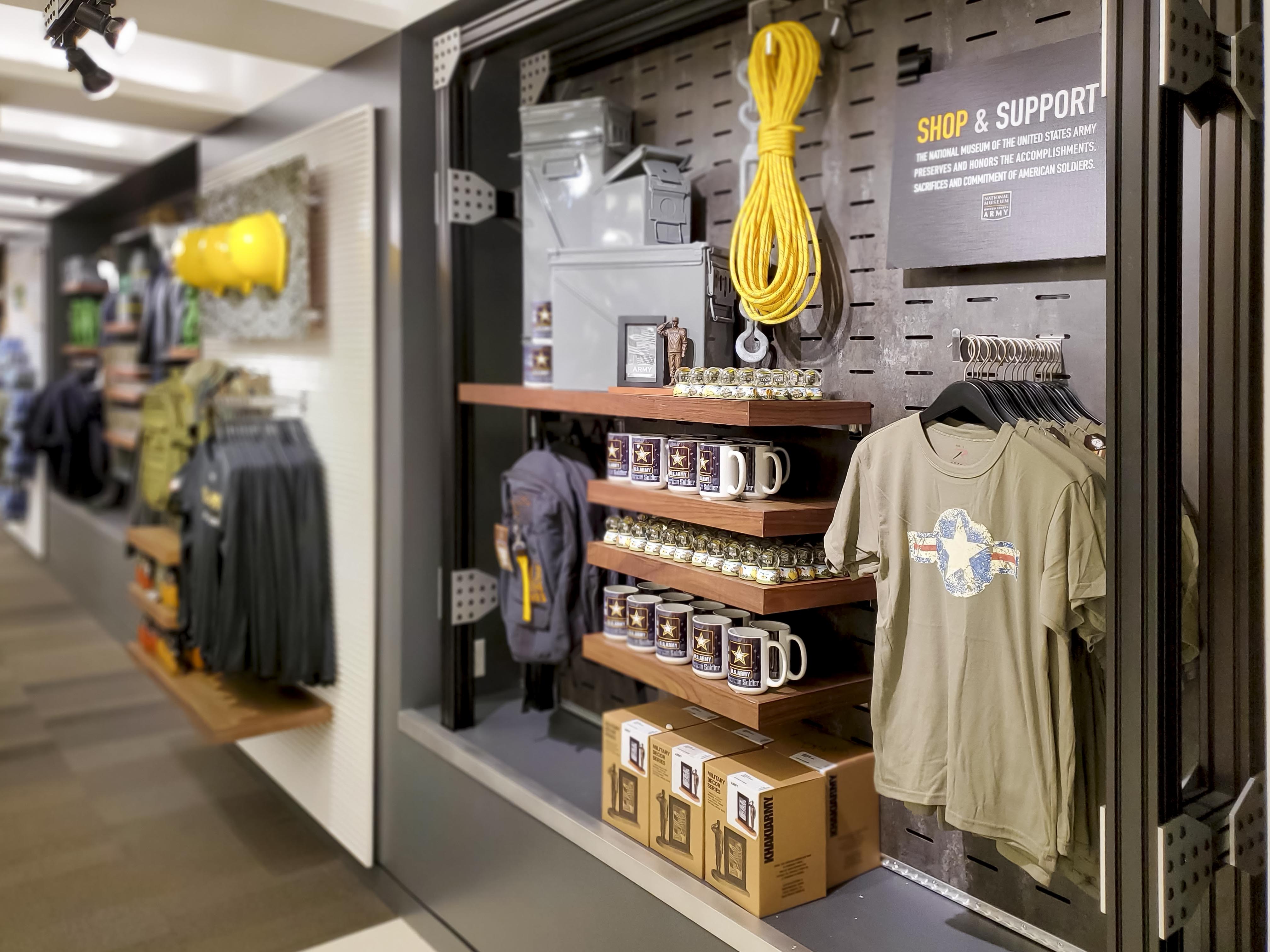 Vintage Army field manuals displayed above the cap wall, lashed in with ratchet straps
