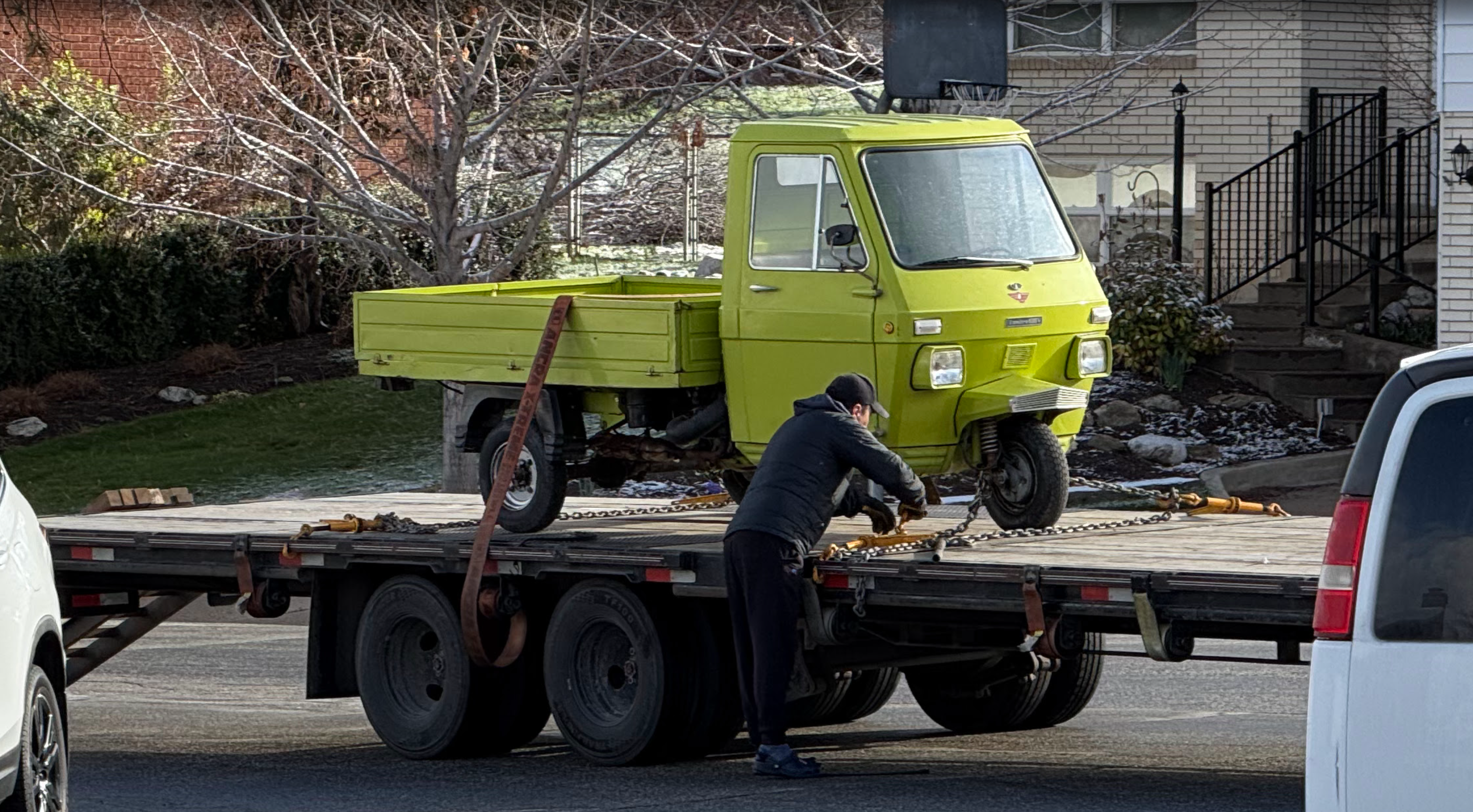 The donor vehicle arrives — a vintage three-wheel utility truck, every panel saved for the conversion