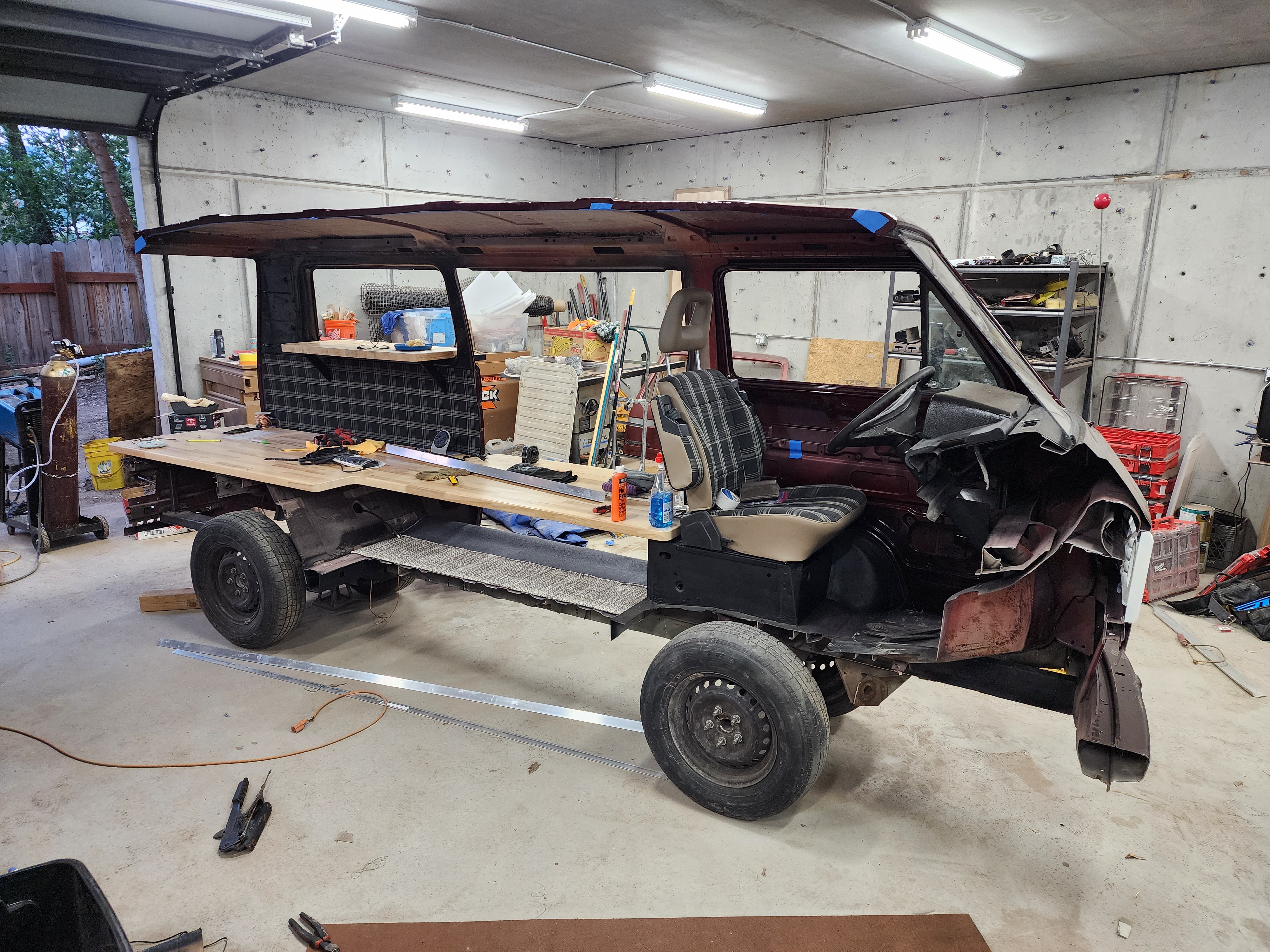 The donor van mid-build in Truman’s shop — chassis sectioned and the print-shop counter taking shape