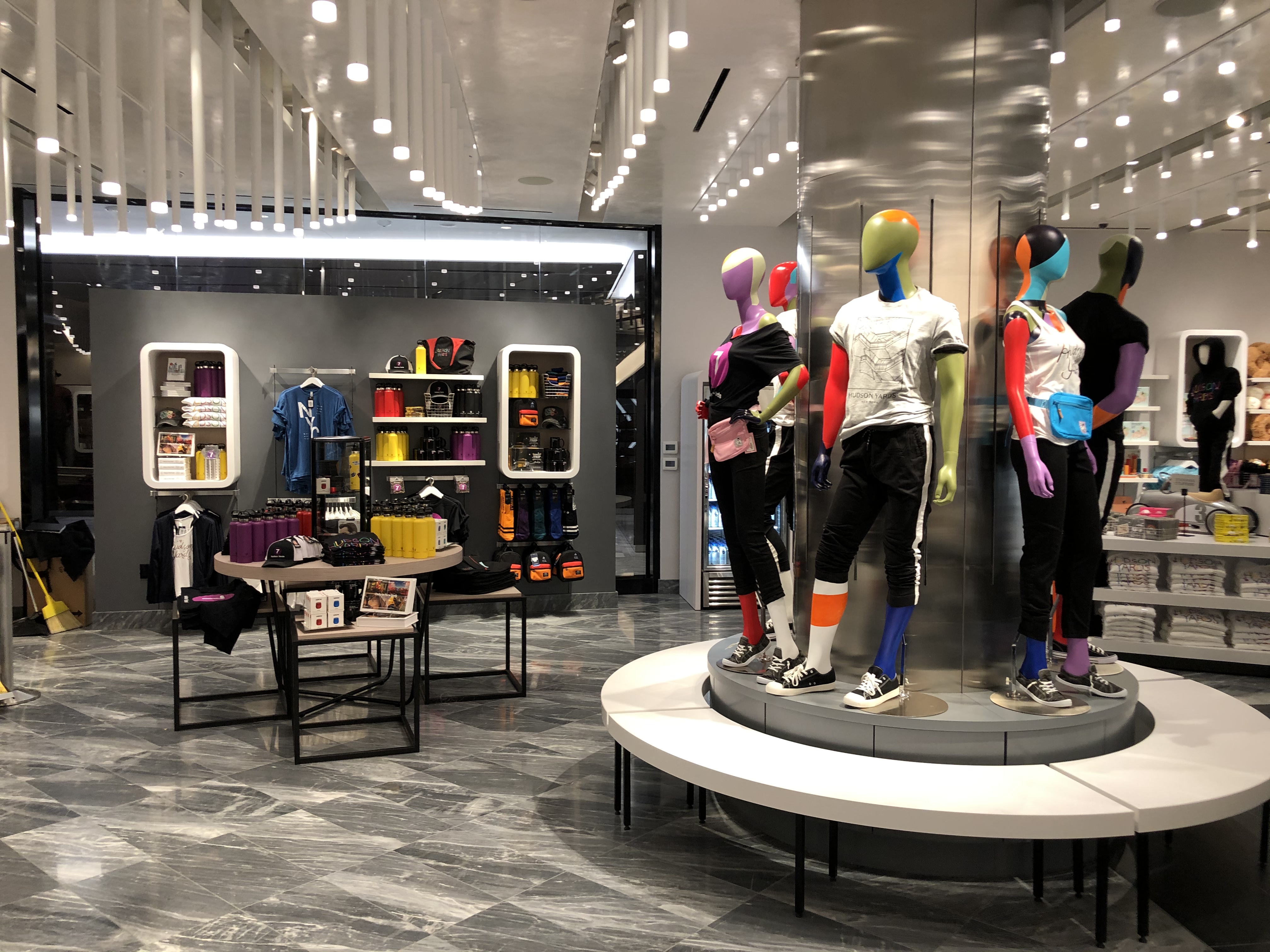 A color-blocked mannequin platform anchors the Hudson Yards exclusive collection