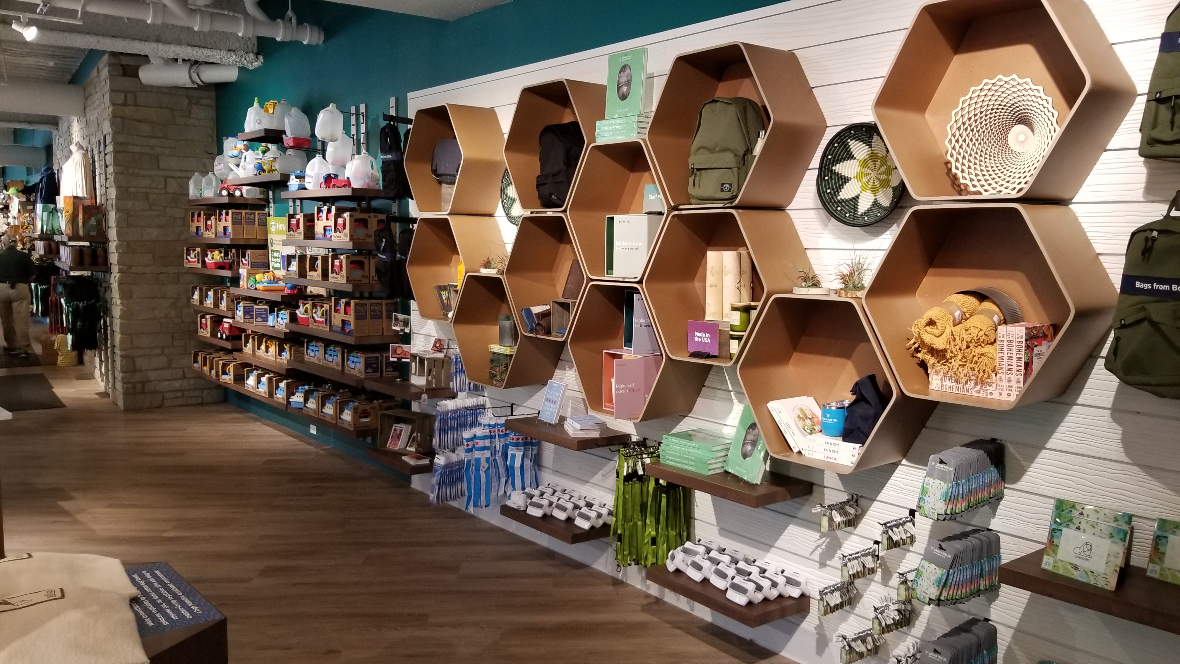 Honeycomb wall displays in reclaimed wood hold sustainable goods and Made-in-USA gifts
