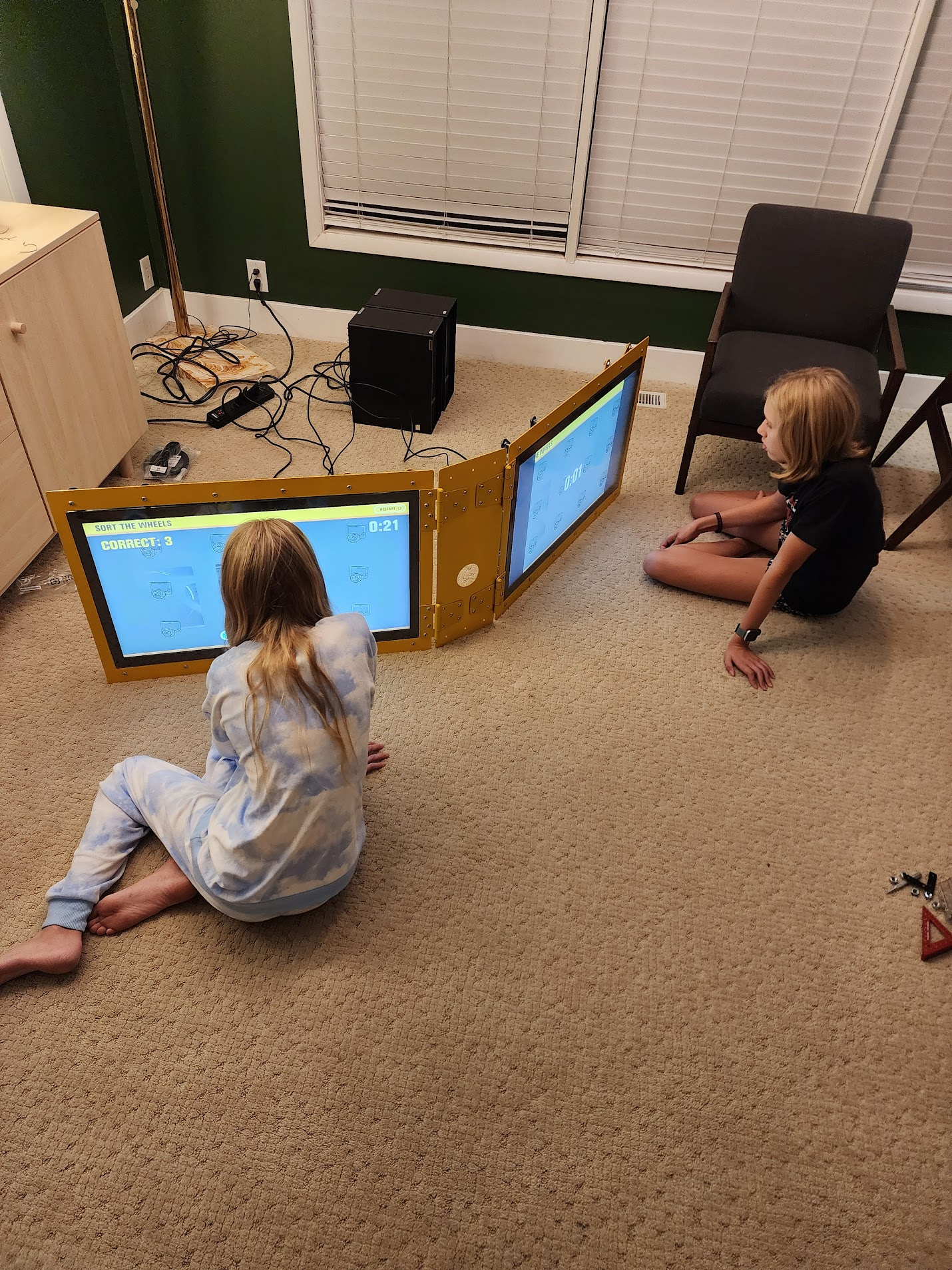 Beta testers play the "Sort the Wheels" inspection game on the dual touchscreens
